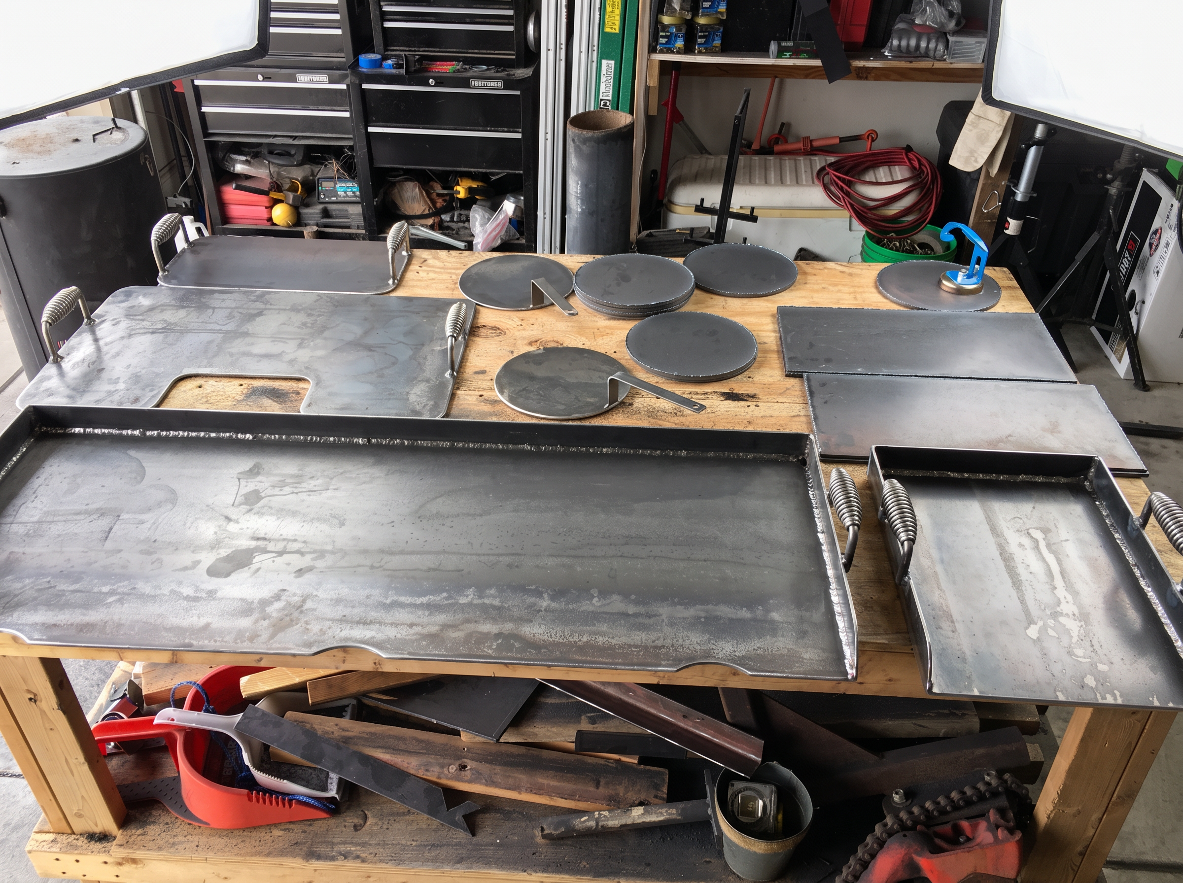 Assorted handmade steel cookware on Martin's bench