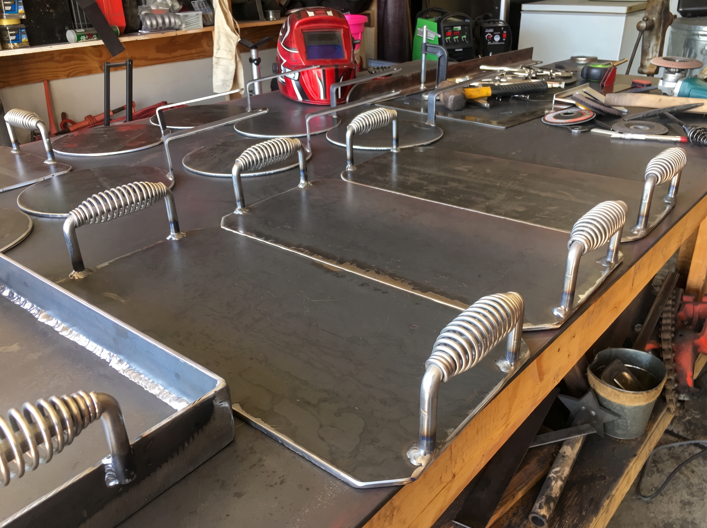 Martin's handmade steel cooking plates and presses on a workbench